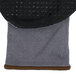 A close up of Cordova Conquest Plus gray and black gloves with black and gray nitrile dots on the palm.