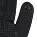A pair of black Cordova Conquest gloves with black nitrile dots on the palm and fingers.