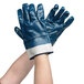 A pair of extra-large Cordova blue nitrile gloves with blue and white stripes on the cuffs.