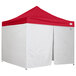 A white tent with a red top and side walls.