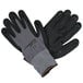 A pair of gray Cordova Conquest gloves with black and gray palms and nitrile dots.