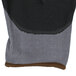 A close up of a grey Cordova Conquest glove with black foam nitrile and polyurethane palm coating.