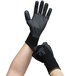 A pair of hands wearing Cordova black warehouse gloves.