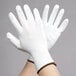 A pair of Cordova white nylon gloves with white polyurethane palms.