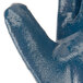 A close up of a blue Cordova Smooth Supported Nitrile glove with a plastic handle.