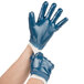 A pair of hands wearing blue Cordova Smooth Supported Nitrile gloves with white jersey lining.