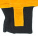 A close up of a Cordova yellow and black double palm mitten.