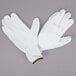 A pair of Cordova white nylon gloves with white polyurethane palm coating.