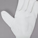 A white Cordova nylon glove with white polyurethane palm coating.