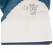 A close up of a large Cordova blue and white nitrile glove with a white label.