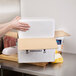 A person's hand holding a Nordic insulated shipping box with food inside.