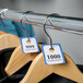 Blue paper coat room check tickets on a metal ring.