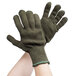 A pair of hands wearing Cordova green work gloves with blue trim.