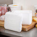 A white styrofoam container with a lid.