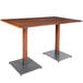 A Lancaster Table & Seating wooden table with metal legs.