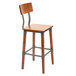 A Lancaster Table & Seating wooden bar stool with a metal back.