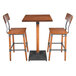 A Lancaster Table & Seating bar height table with a live edge wood surface and two bar chairs.