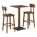 A square bar height table with a rustic walnut finish and two matching bar stools featuring wood and metal construction.