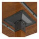 A close-up view of the underside of a square wooden bar-height table with a metal mounting bracket.