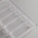 A clear plastic tray with rows of small rectangular compartments.