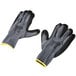 A pair of Cordova gray and yellow work gloves with black sandy nitrile palms on a white background.