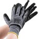 A pair of gray Cordova Cor-Touch gloves with black sandy nitrile palm coating over a white background.