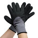 A pair of Cordova Conquest Max gray and black gloves with black foam nitrile and nitrile dots on white background.