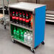 A Lakeside metal utility cart with bottles of soda and water on it.
