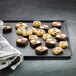 A Matfer Bourgeat aluminum sheet pan with chocolate cookies on it.