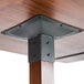 A Lancaster Table & Seating solid wood live edge bar height table with metal legs.
