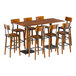 A Lancaster Table & Seating bar height table with live edge and 8 bar stools around it.