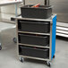 A Lakeside metal utility cart with black bins on it.