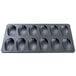 A black baking tray with shell-shaped molds.