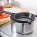 A Matfer Bourgeat sieve and a bowl on a counter.