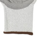 A white and brown knit glove with gray polyurethane and TPR coating.