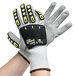 A pair of Cordova medium OGRE-CR gloves with gray, black, and yellow safety gloves.