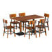 A Lancaster Table & Seating rustic walnut live edge table with metal legs and six chairs.