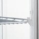 A white shelf with a metal rack inside an Avantco countertop display refrigerator.