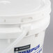 A white bucket with a plastic handle and a lid.