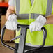 A person wearing Cordova gray leather driver's gloves holding a forklift.