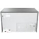 The back of a white and grey Manitowoc Indigo NXT water cooled ice machine with a black rectangular top.