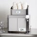 A silver Campus Products GP8 Stemshine electric glass polisher machine with white paper in it.