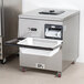 A grey rectangular Campus Products CDM-6K Silvershine cutlery dryer/polisher machine on a counter.