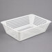 A white plastic perforated drain box.