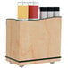 A Lakeside serving cart with Hard Rock Maple laminate and adjustable ledges holding condiment containers.