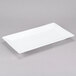 a white rectangular plate on a gray surface