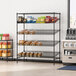 A Regency black epoxy shelving frame in a hospital cafeteria with food on the shelf.