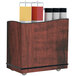 A Lakeside serving cart with red maple laminate finish and adjustable ledges holding condiment containers.