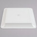 A white square Fineline plastic catering tray with a circle in the center.