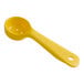 A yellow plastic Carlisle Measure Misers portion spoon with a short handle and holes.